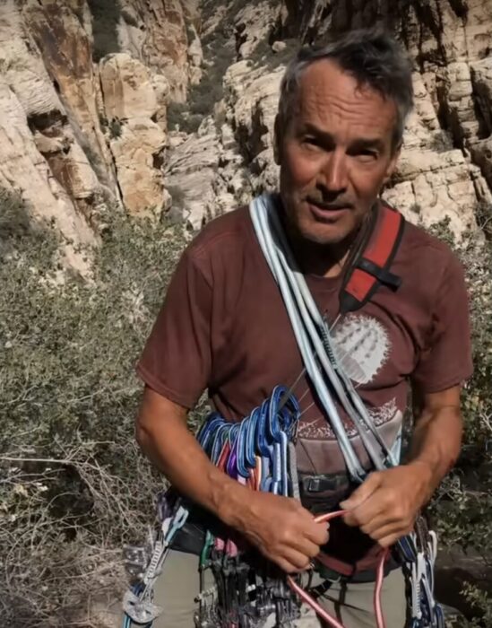 male climber arranging equipment on a harness